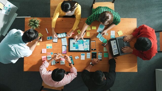 Fototapeta Top view of software developer writing idea about Ux ui design for mobile phone interface. Programmer brainstorm and planning wireframe prototype by looking tablet display smart software. Convocation.