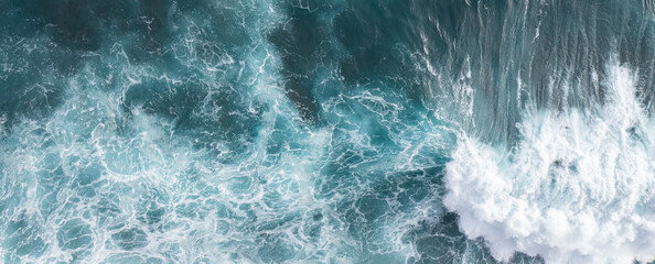 Drone view of rough ocean surf and waves hitting the rocky shoreline