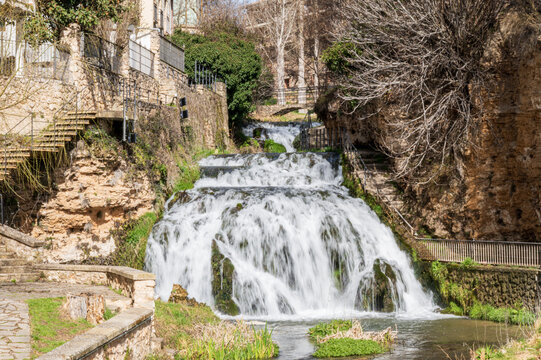 Waterfall that splits the town of Trillo De Guadalajara (Castilla La Mancha-Spain) in two. You can see the houses on one side of the waterfall, with beautiful views. There is a staircase to be able