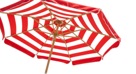 Vibrant red and black striped beach umbrella casting a shadow against a dark background evoking summer fun and protection from the sun