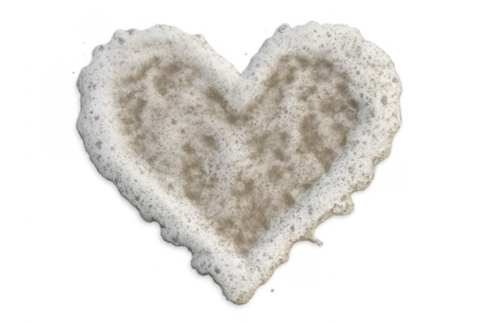 Heart shape formed by ocean foam on sand