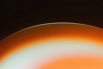 Vibrant Sunset Abstract: Capturing the mesmerizing dance of light and shadow, the image presents an abstract composition, showcasing the captivating fusion of warm orange hues and a sleek.