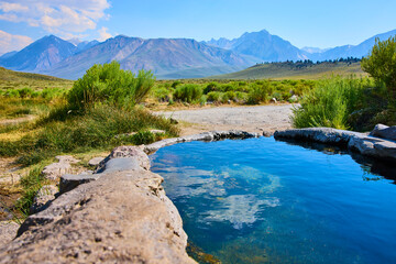Rock Tub Hot Springs Natural Pool and Sierra Nevada Mountains in Summer Sunlight