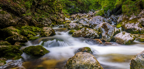 Long exposure of a small stream flowing over rocks,	