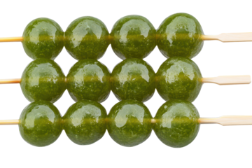 Authentic Japanese matcha dango skewers prepared with care and served at a traditional Japanese festival