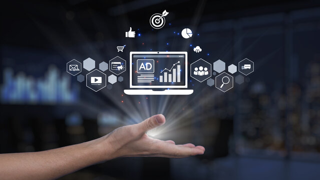 A striking digital transformation concept with a hand reaching out towards a laptop displaying analytics and advertisement visuals, symbolizing innovative marketing solutions. Synapse