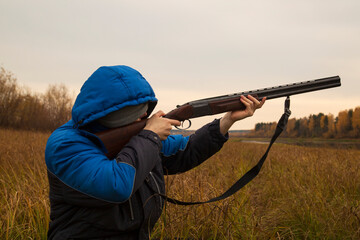 Naklejka premium Duck hunting . A man with a gun on a duck hunt.