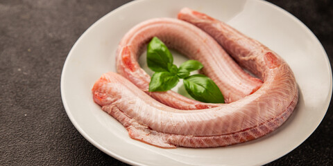 Raw rock eel fish rock salmon shark seafood small-spotted catshark tasty snack fresh delicious gourmet food background on the table rustic top view copy space pescetarian diet