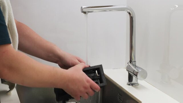 Washing a Removable Espresso Machine Brew Group Under Running Tap