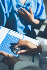 healthy concept; Doctor checking patient's heart with stethoscope at a hospital