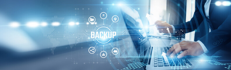Businessman using laptop and backup analyzing technological data, disaster recovery, cloud storage, data redundancy, cybersecurity protection, automated backups, recovery systems