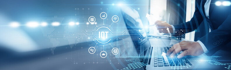 Businessman using laptop and IoT analyzing technological data, connected devices, real-time monitoring, smart home technology, industrial IoT, cloud computing, and data-driven automation.