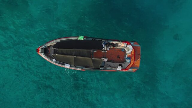 Drone view of boat floating on turquoise waters in Albania