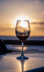 glass of red wine on a table at sunset on a winter day punta del este in uruguay at golden hour