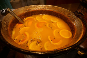 Hot mulled wine with lemon and other citrus fruits
