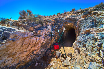Abandoned Mine Entrance with Warning Sign and Desert Landscape in Nevada
