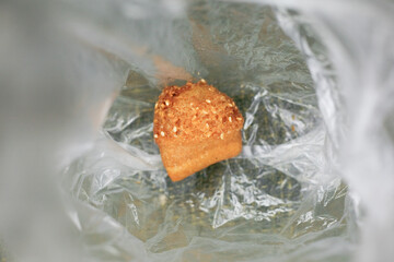 Close up of Indonesian sweet fried bread with sesame seeds in transparent plastic bag