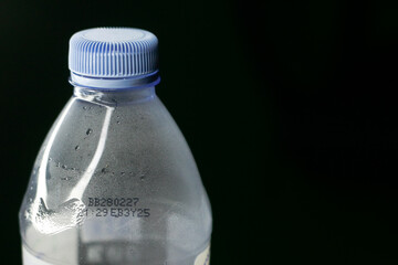 Close up of plastic bottled drinking water isolated on black background