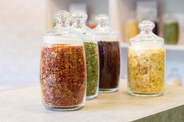 Herbs and seasonings in glass jars on the counter