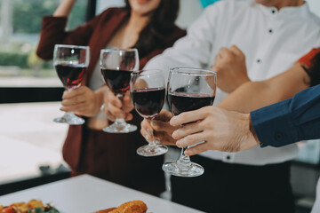 Diversity, dinner and group of people toast celebration together at party. Friends, happy and celebrate with food, wine and friendship for love, support and cheers champagne at business function