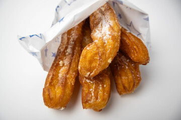 Spanish churros in a takeout bag