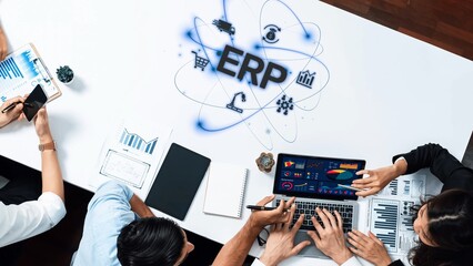 A dynamic business meeting showcasing professionals engaging with digital tools to discuss ERP solutions, data analytics, and strategies for improving organizational efficiency. Raster