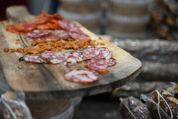 A meat board with a few different smoked sausages