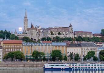 Fototapeta premium A Full Moon Near the Fishermans Bastion and The Church of Our Lady of Buda Castle in Budapest Hungary
