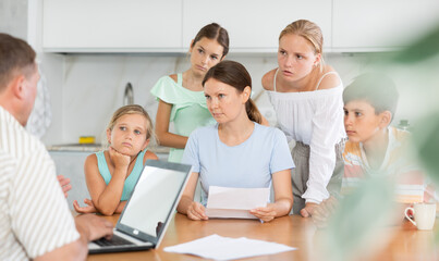 Solo mother with four children having visit of Social services worker informing about refusal of benefit