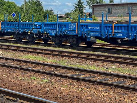 Lubliniec, Poland, June 17, 2025: Sets of blue freight train cars stand on the tracks at the train station in Lubliniec, Poland