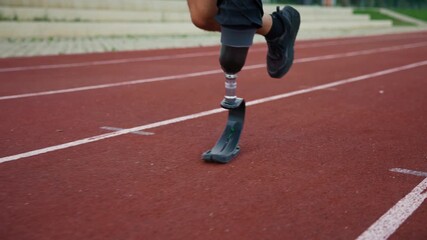 Male athlete running safely and confidently using a transtibial prosthesis with a sports blade and enjoying an active life, close up shot. - Powered by Adobe