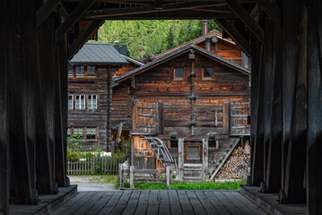 View of the village of Reckingen in Switzerland seen from the wooden bridge across river rotten