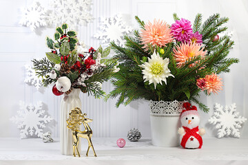 Christmas Eve concept. Christmas and New Year's mockup for design and product display, a creative Christmas bouquet of fresh fir branches in a vase with chrysanthemum flowers and decorations
