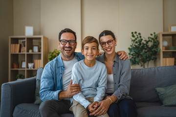 Fototapeta premium Happy family with son relaxing together on couch