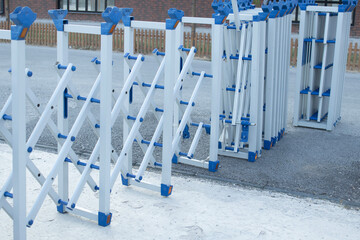 Expandable scissor barrier on urban roadway. Portable retractable gate for safety, traffic control,...