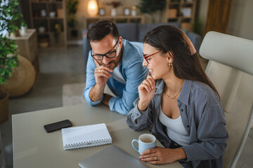 Couple collaborating on business project at home office