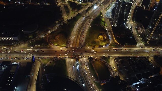 Top down aerial view of heavy car traffic on javier prado avenue interchange in lima, peru, at night