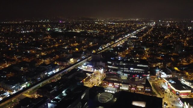 Aerial drone shot flying over the illuminated districts of san borja and san luis in lima, peru at
