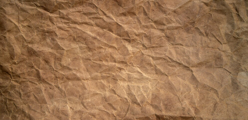 A photo of the texture of old paper.Brown crumpled paper.