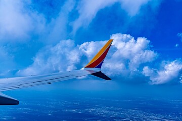 View of a wing from a plane as viewed from the plane window while flying through the sky