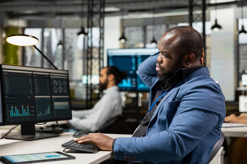 African american executive manager in a brainstorming session, searching for new ideas to increase...