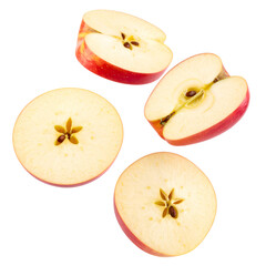 Sliced red apples on a black background, showcasing the interior seeds and flesh