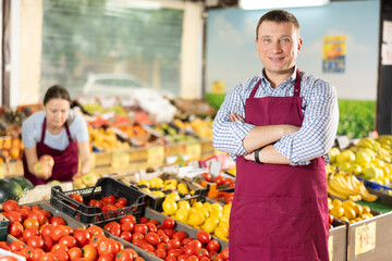 Portrait of an smiling supermarket worker in a sales floor