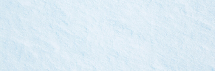 Natural snow texture. Smooth surface of clean fresh snow. Snowy ground. Wide panoramic winter background with snow patterns. Perfect for Christmas and New Year design. Closeup top view.