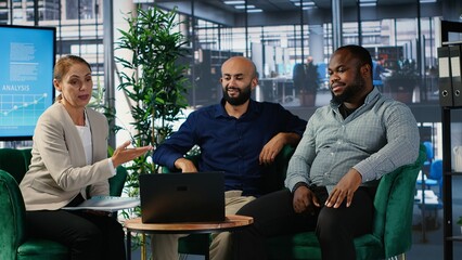 Business people attending an online web conference during a meeting, reviewing performance metrics and insights. Experts ensuring global development and success story. Camera B.