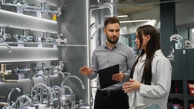 Sales consultant assisting customer in plumbing store showroom