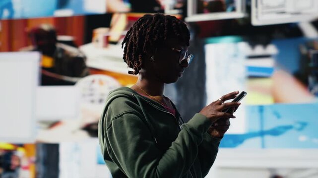 Woman using mobile phone pleased by access to video recommendations delivered instantly. Joyous user immersed clips on smartphone during digital era enabling unlimited streaming, camera B