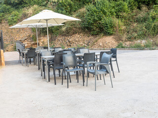 Outdoor cafe tables and chairs with sun umbrella