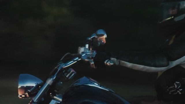 Close up of two bikers wearing helmets and leather jackets riding motorcycle in evening light, faces partially visible through visors, with background fading into dark forest scenery in motion