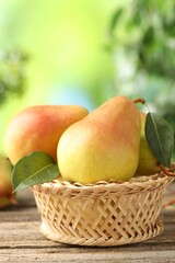 Fresh ripe pears on wooden table outdoors, closeup